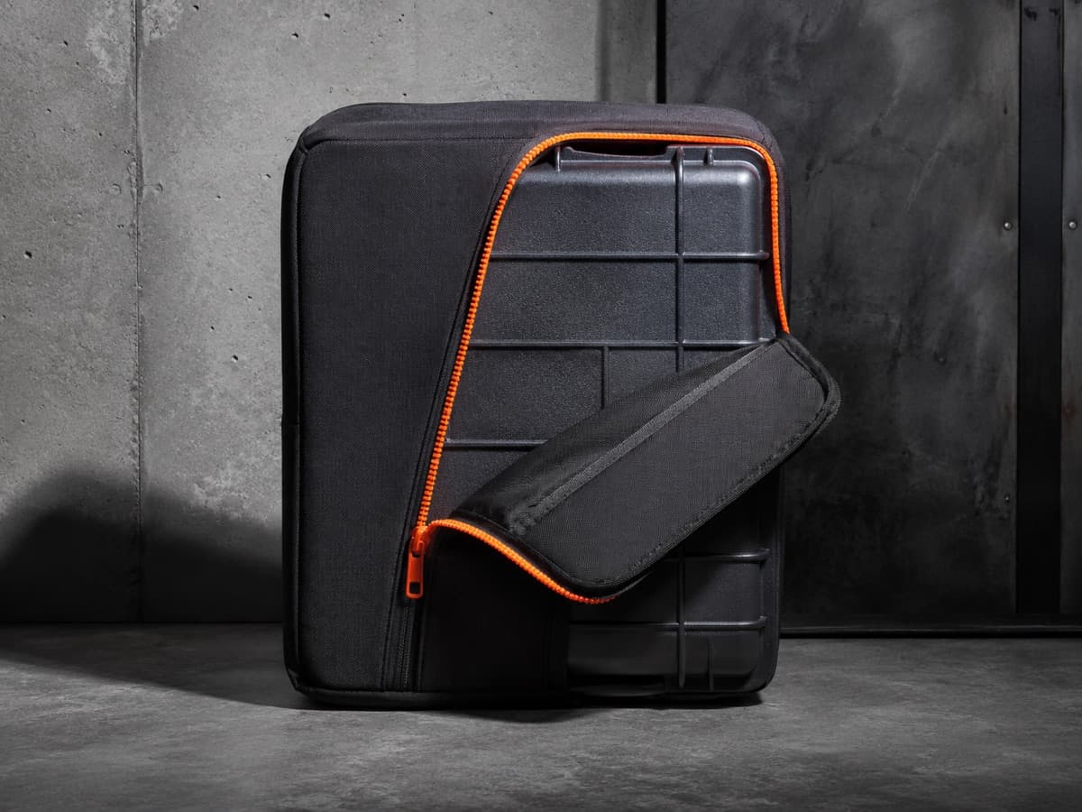 A case cover with its side access zipper half open, the flap folded back off the shell.