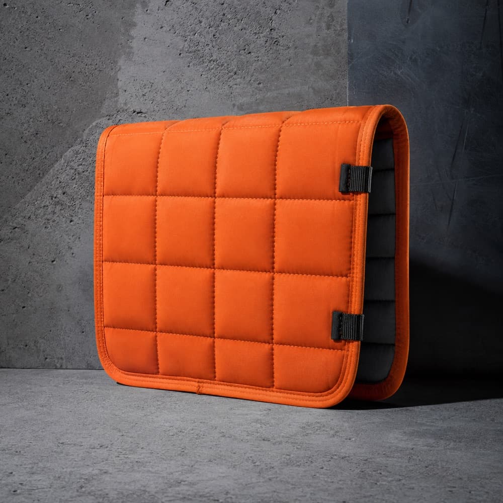 A quilted padded cover folded once, its padded cross-section visible.
