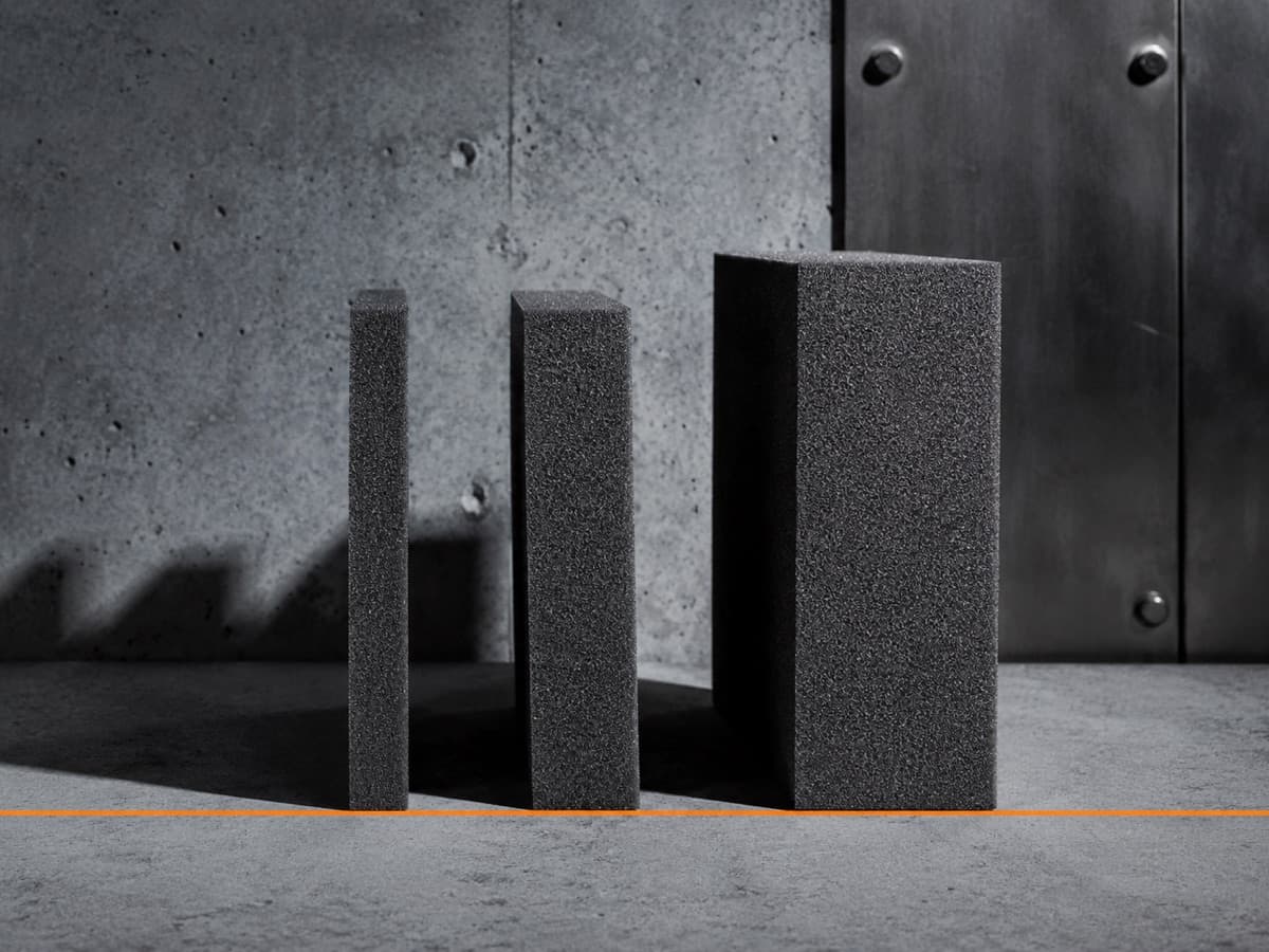 Three foam sample blocks of different thicknesses standing on edge, cut faces to camera.